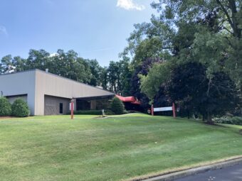 A one-story office building with a sign in front that reads "Stantec"